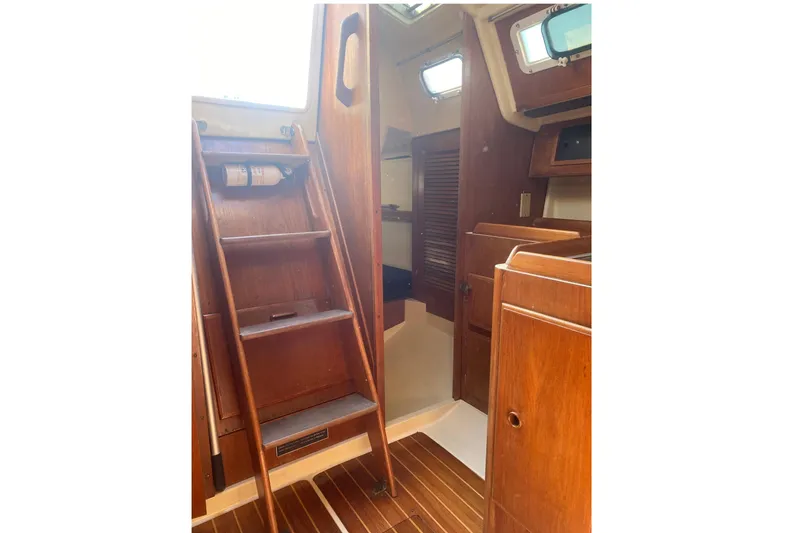 Slide: The Image of Interior of 1986 Pearson 28 sailboat with wooden stairs and cabinetry. - 18