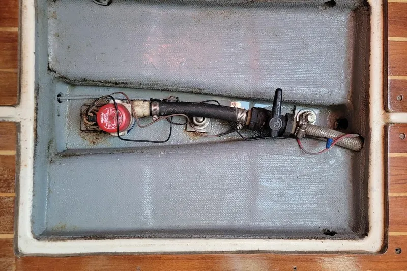 Slide: The Image of Bilge compartment of 1986 Pearson 28 sailboat with fuel line and valve. - 21
