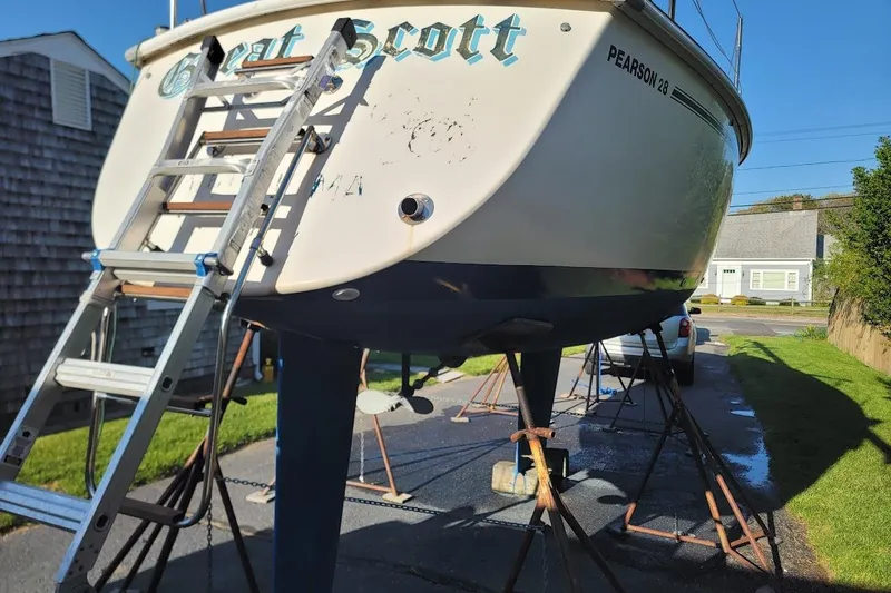 Slide: The Image of Pearson 28 sailboat from 1986 on stands, with ladder for maintenance. - 25