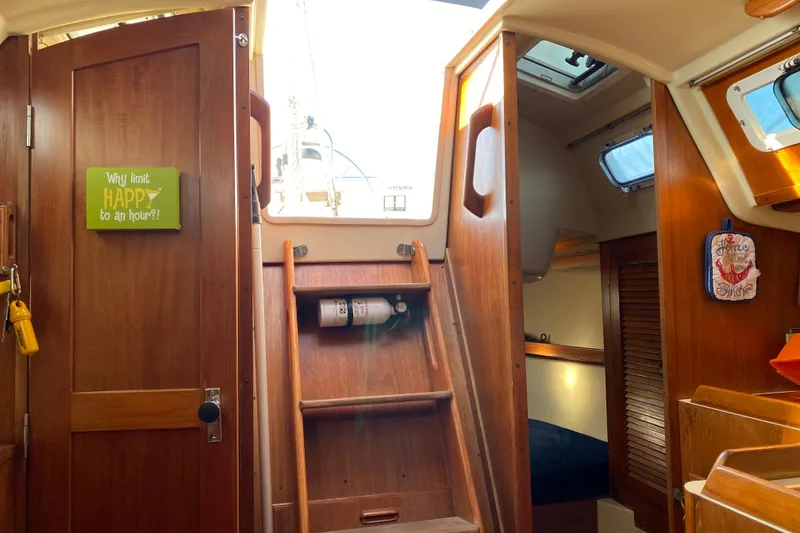 Slide: The Image of Interior of a 1986 Pearson 28 sailboat with wooden finishes and cozy cabin space. - 5