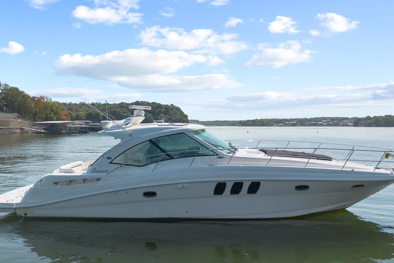 Slide: The Image of 2006 Sea Ray 48 Sundancer yacht on calm water under a clear sky. - 9