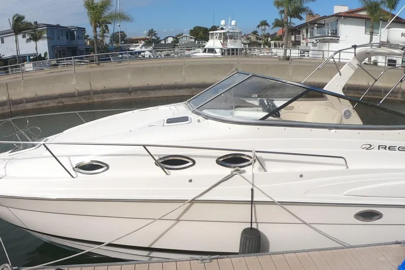 The Image of 2005 Regal Commodore 2860 boat docked in a marina with palm trees. - 0