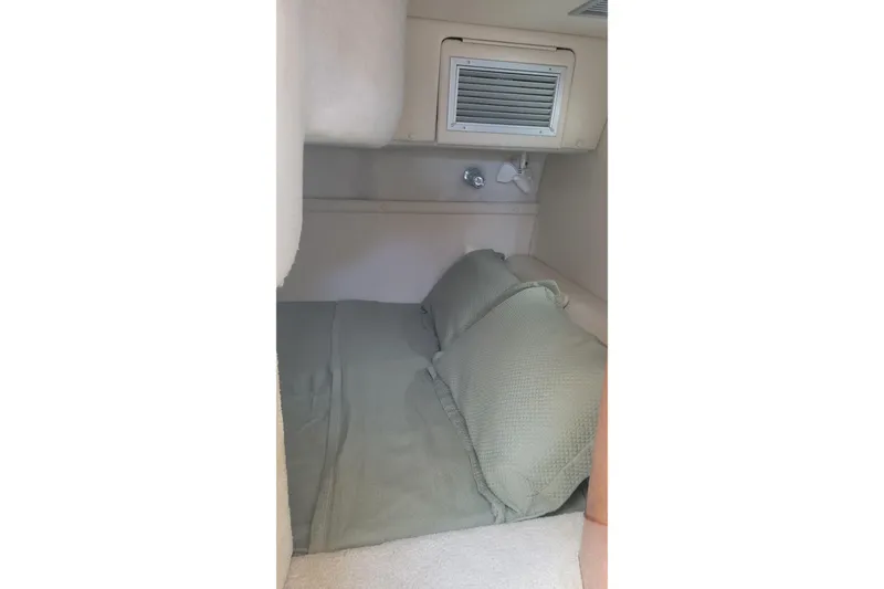Slide: The Image of Cozy cabin interior of 2005 Regal Commodore 2860 with green bedding. - 13