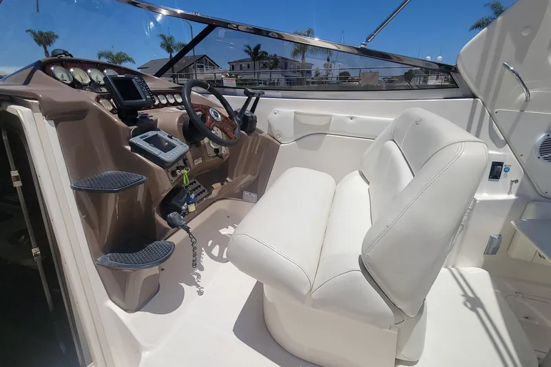 Slide: The Image of Interior of 2005 Regal Commodore 2860 boat, featuring kitchenette and seating area. - 19
