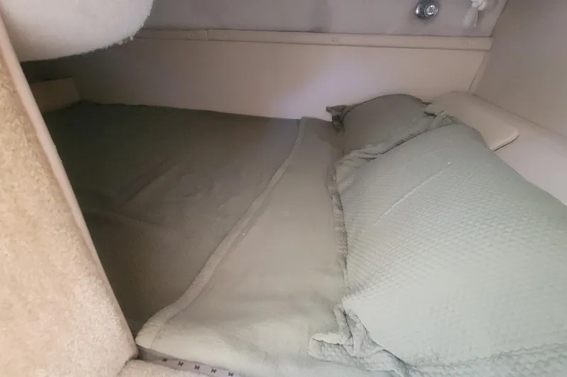 Slide: The Image of Cozy sleeping area inside a 2005 Regal Commodore 2860 boat cabin. - 20