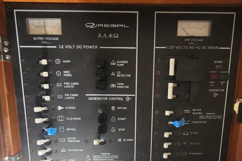 Slide: The Image of Electrical control panel of a 2005 Regal Commodore 2860 boat, featuring switches and voltage meters. - 23