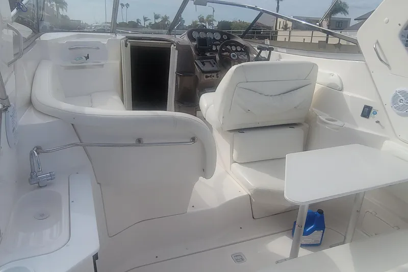 Slide: The Image of 2005 Regal Commodore 2860 boat interior with seating, steering, and table setup. - 4