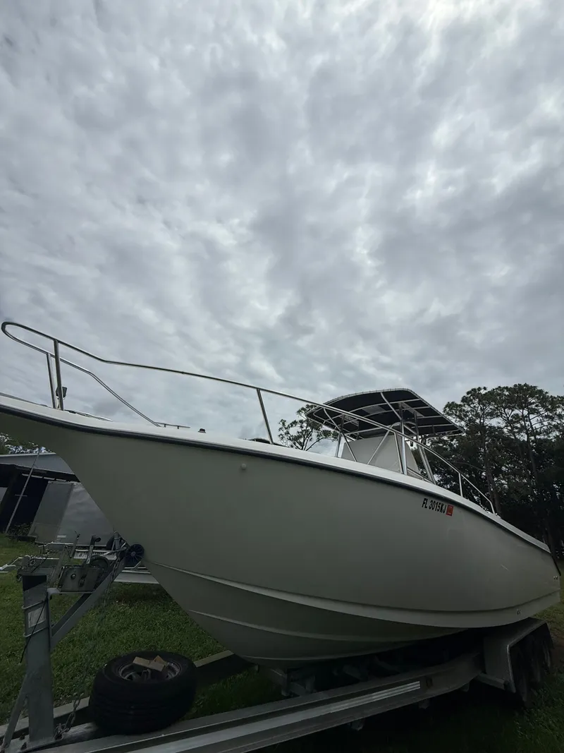 The Image of 1998 Century 3000 boat on trailer under cloudy sky. - 0