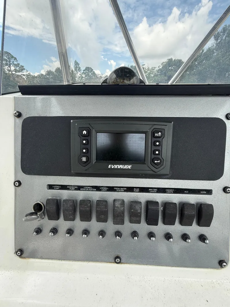 Slide: The Image of Dashboard of a 1998 Century 3000 boat with Evinrude controls. - 10