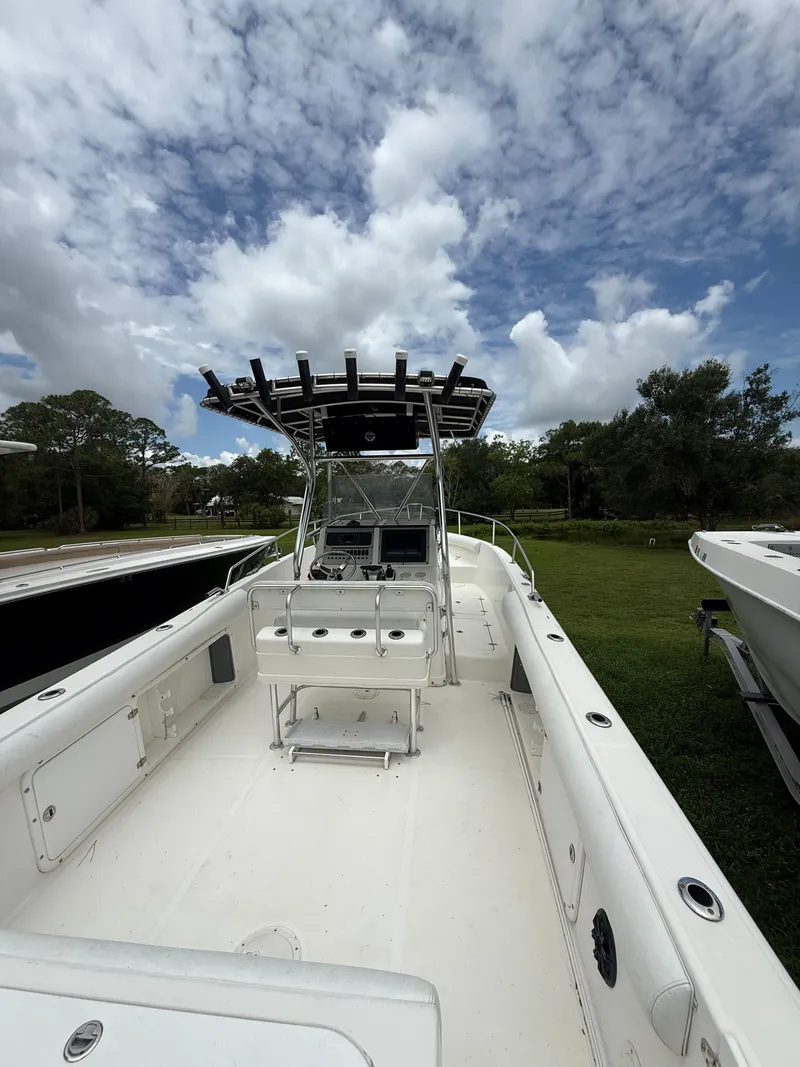 Slide: The Image of 1998 Century 3000 boat on grass under cloudy sky. - 15