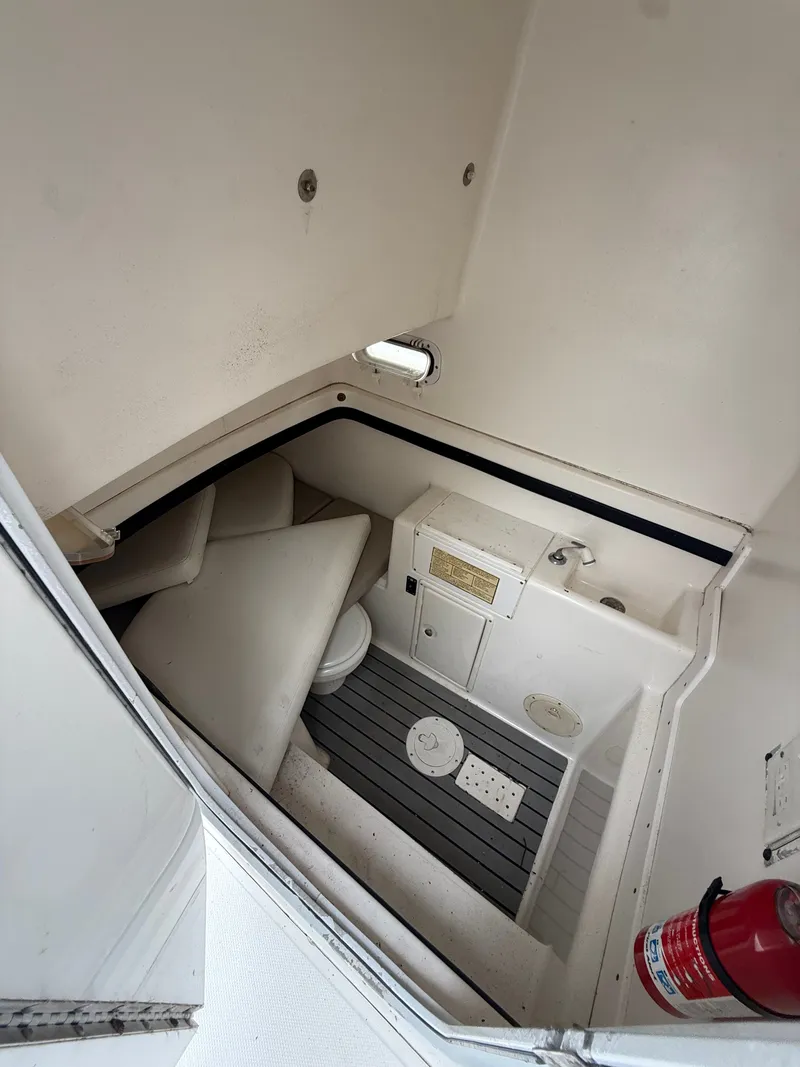 Slide: The Image of Interior of a 1998 Century 3000 boat with toilet and fire extinguisher. - 22