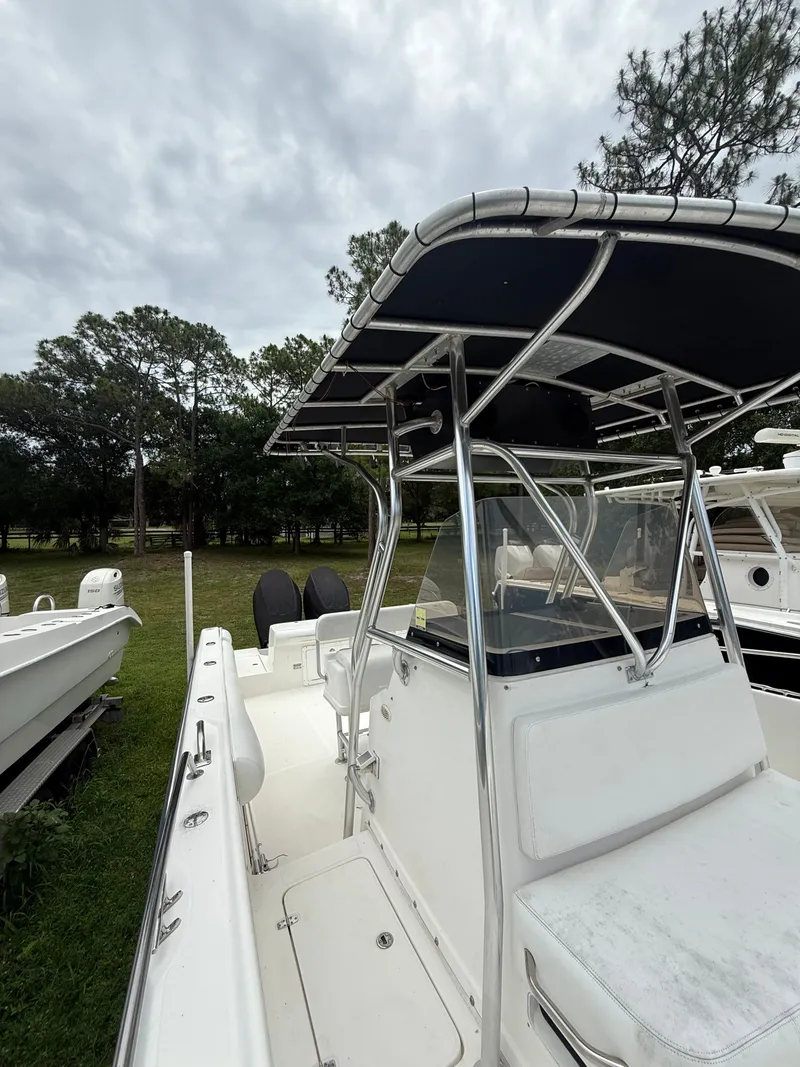 Slide: The Image of 1998 Century 3000 boat with T-top parked on grass. - 3