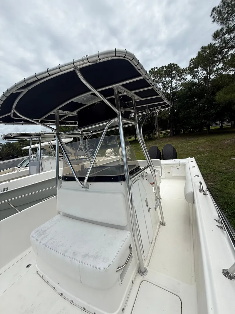 Slide: The Image of 1998 Century 3000 boat with T-top and seating, cloudy sky. - 4