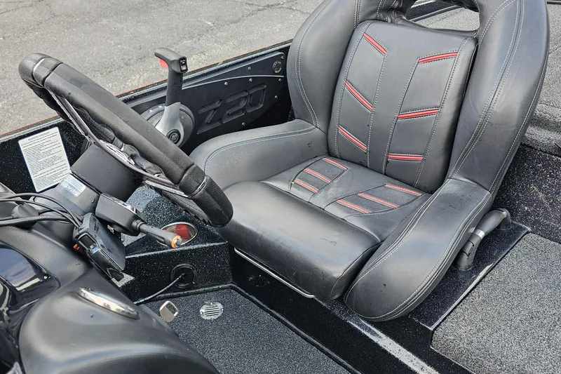 Slide: The Image of Interior of a 2017 Nitro Z20 Pro boat featuring a sleek black and red seat design. - 22