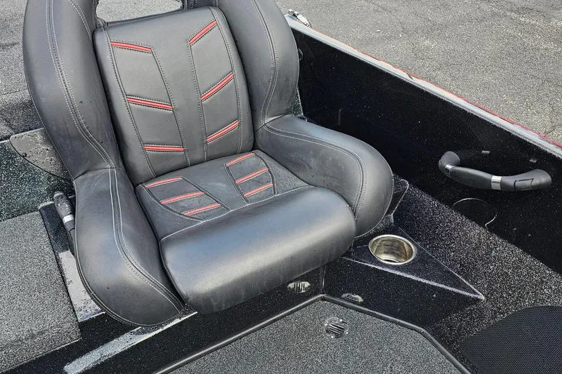 Slide: The Image of Black and red seat in a 2017 Nitro Z20 Pro boat, featuring cup holder and textured flooring. - 24