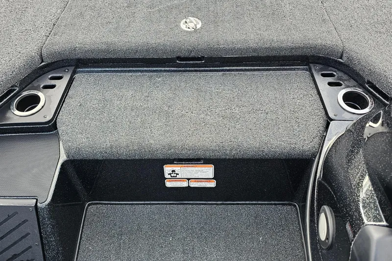 Slide: The Image of Interior of a 2017 Nitro Z20 Pro boat, featuring carpeted flooring and cup holders. - 26
