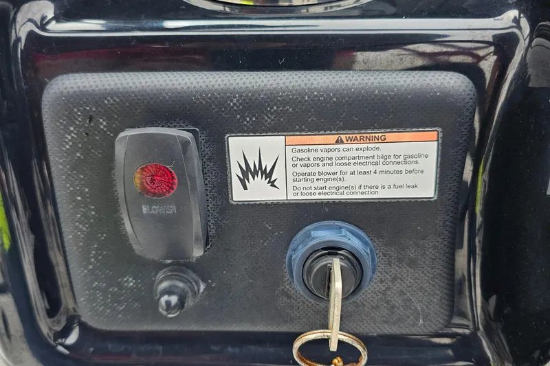 Slide: The Image of 2019 Yamaha Boats AR195 ignition panel with warning label and blower switch. - 12