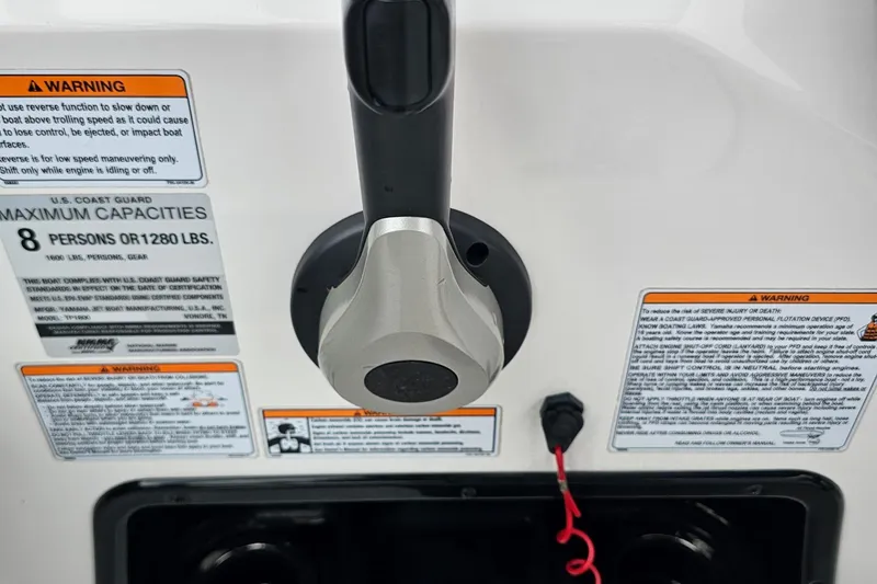 Slide: The Image of Close-up of 2019 Yamaha AR195 boat controls and safety warnings. - 13
