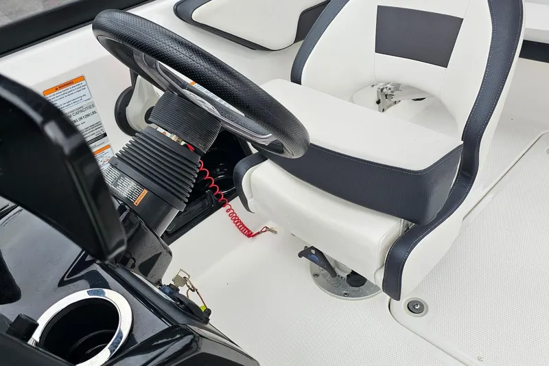 Slide: The Image of 2019 Yamaha Boats AR195 cockpit with steering wheel and white seat. - 15