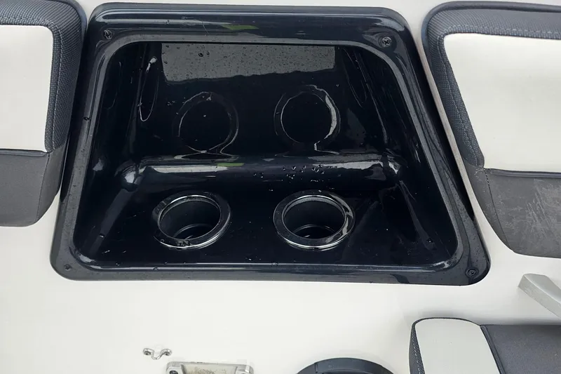 Slide: The Image of Cup holders on a 2019 Yamaha Boats AR195, featuring a sleek black design. - 16