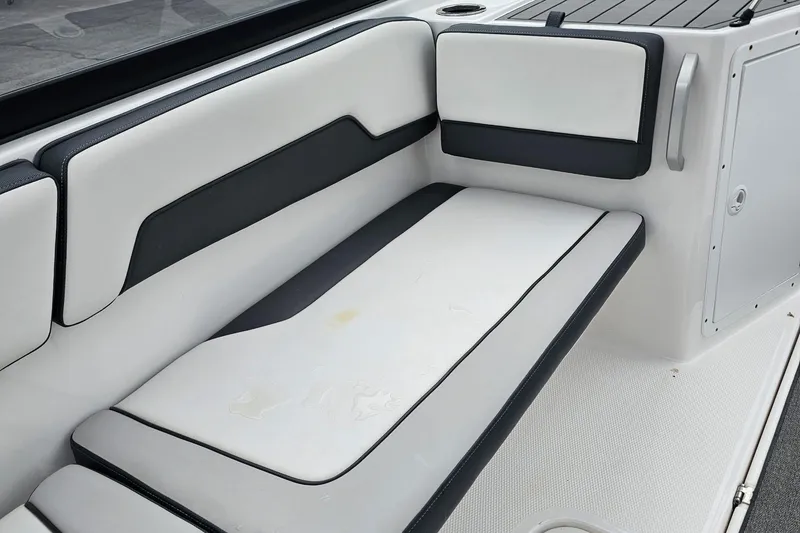 Slide: The Image of 2019 Yamaha Boats AR195 interior seating with sleek white and black upholstery. - 21