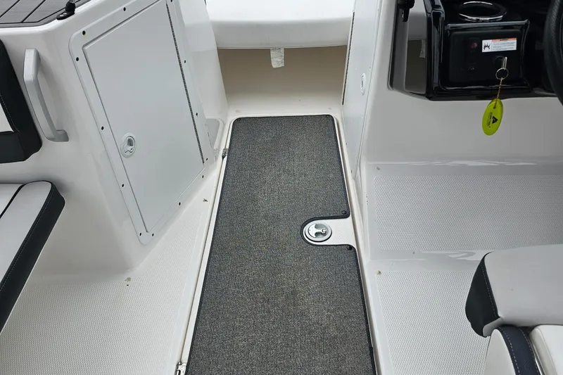 Slide: The Image of 2019 Yamaha Boats AR195 interior with storage compartment and seating area. - 22