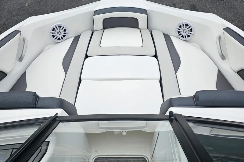 Slide: The Image of 2019 Yamaha Boats AR195 interior with white and gray seating, featuring built-in speakers. - 25