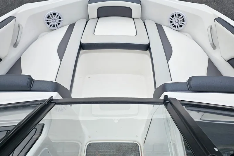 Slide: The Image of 2019 Yamaha Boats AR195 interior with white and gray seating, featuring built-in speakers. - 26
