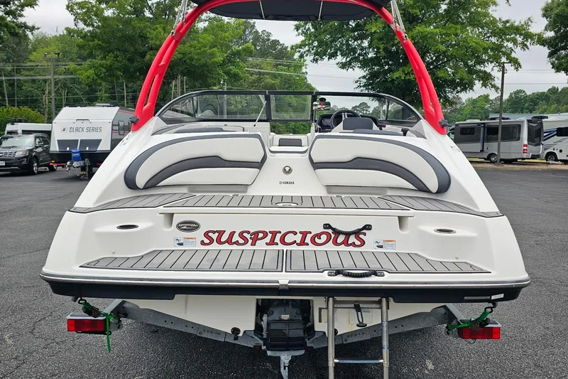 Slide: The Image of 2019 Yamaha Boats AR195 with red accents, parked outdoors, featuring "Suspicious" name on the stern. - 5