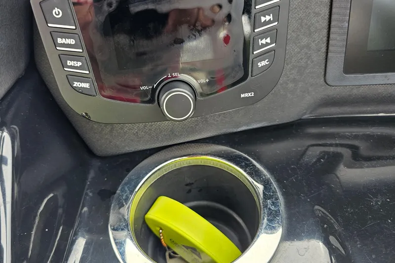 Slide: The Image of Control panel of a 2019 Yamaha Boats AR195 with cup holder and key fob. - 8