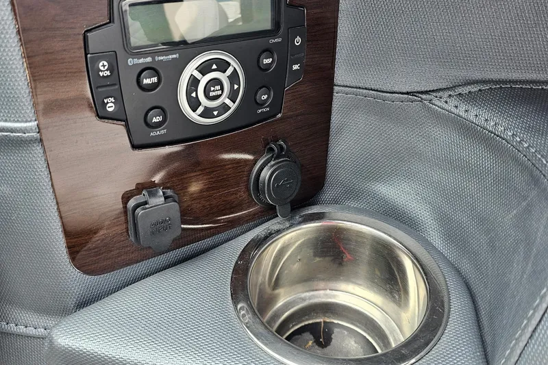 Slide: The Image of Control panel and cup holder in 2021 Chaparral 307 SSX boat interior. - 10