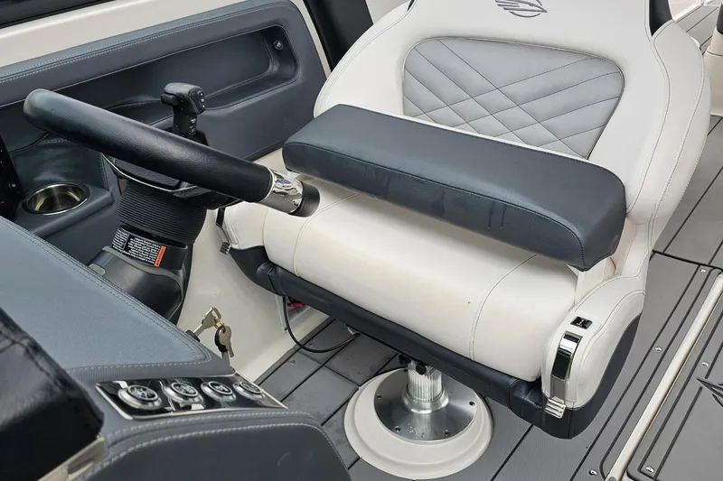 Slide: The Image of Captain's seat and steering wheel of 2021 Chaparral 307 SSX boat interior. - 13