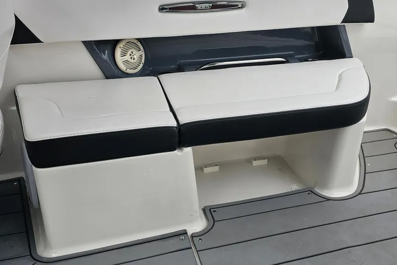 Slide: The Image of 2021 Chaparral 307 SSX boat seating area with integrated speaker and sleek design. - 15