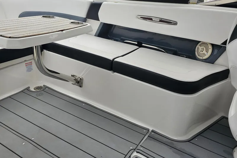 Slide: The Image of 2021 Chaparral 307 SSX boat interior with seating and table, featuring sleek design and modern finishes. - 17