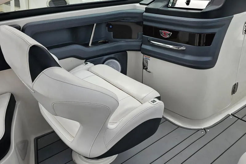 Slide: The Image of Interior of 2021 Chaparral 307 SSX boat featuring sleek white seating and modern dashboard. - 18