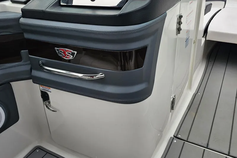 Slide: The Image of Interior detail of 2021 Chaparral 307 SSX boat, featuring sleek design and SS emblem. - 21