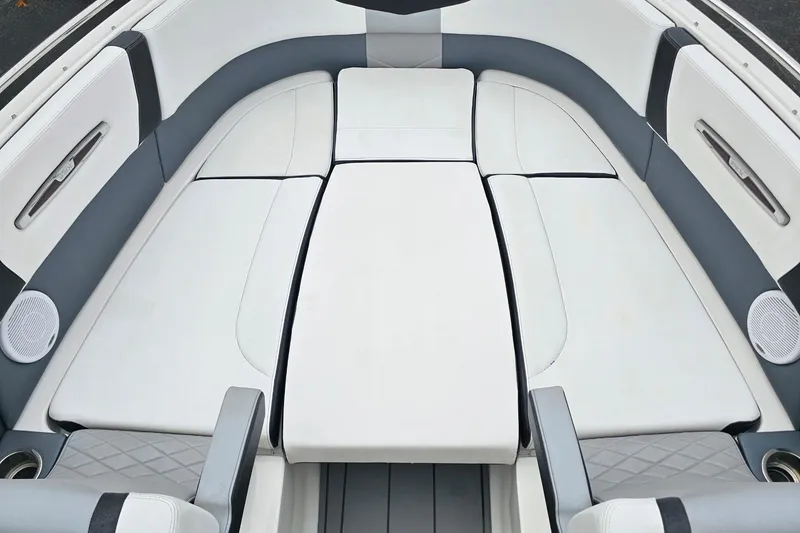 Slide: The Image of 2021 Chaparral 307 SSX boat interior with luxurious white and gray seating arrangement. - 27