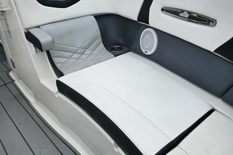 Slide: The Image of 2021 Chaparral 307 SSX boat interior with cushioned seating and speaker. - 29