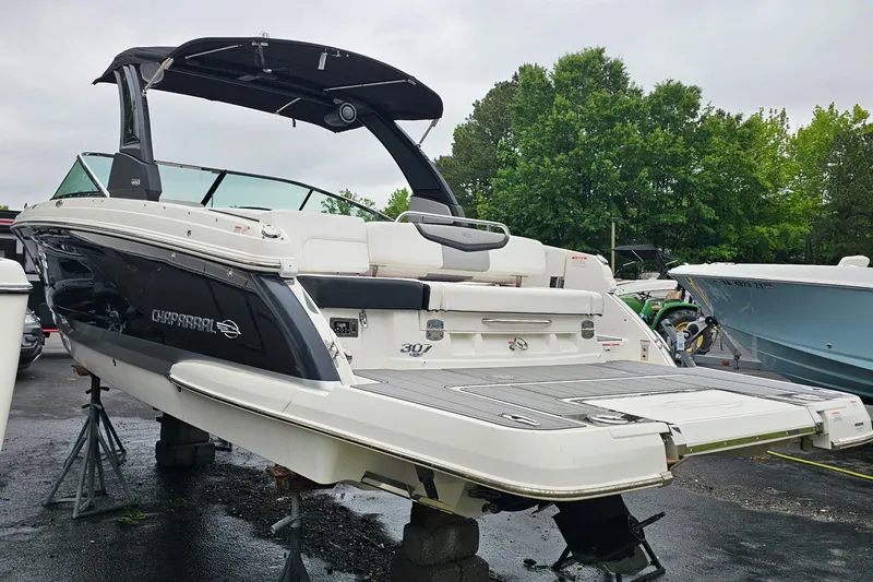 Slide: The Image of 2021 Chaparral 307 SSX boat on stands, featuring sleek design and spacious deck. - 3