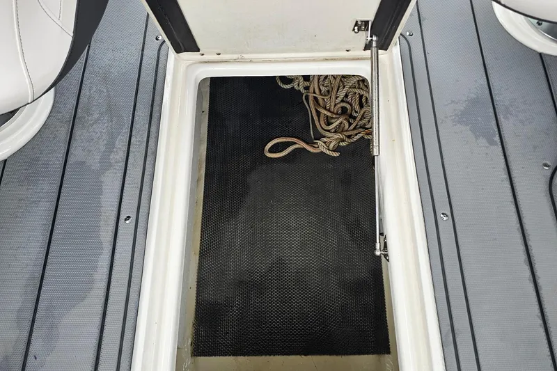 Slide: The Image of Storage compartment with ropes on a 2021 Chaparral 307 SSX boat deck. - 33