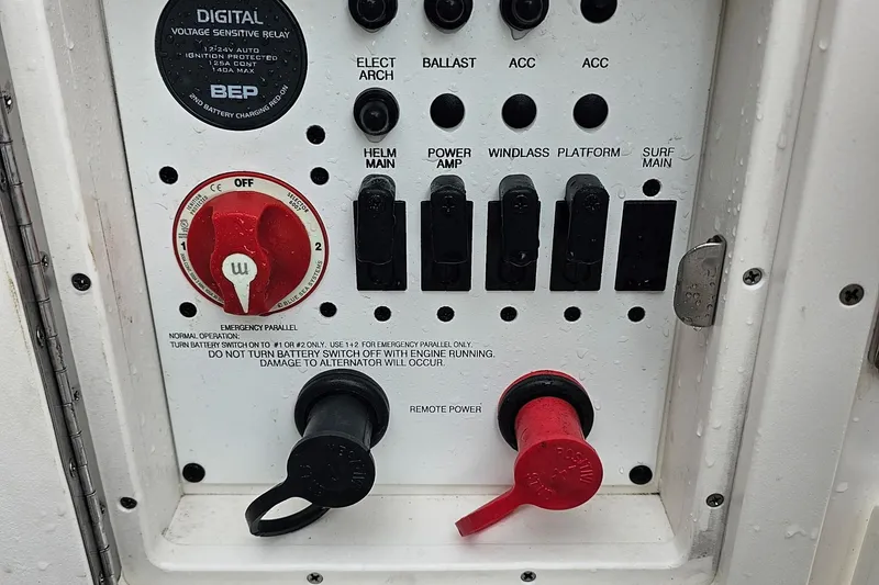 Slide: The Image of Control panel of a 2021 Chaparral 307 SSX boat with switches and battery controls. - 36