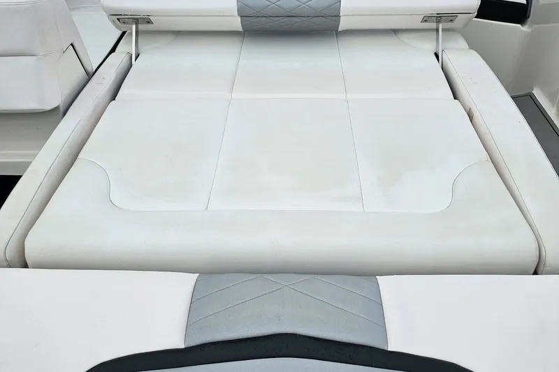 Slide: The Image of 2021 Chaparral 307 SSX boat interior with white cushioned seating. - 37