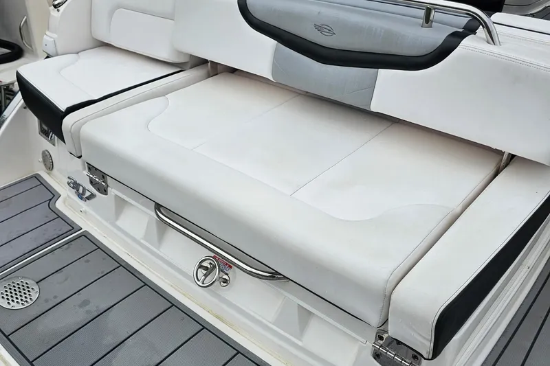 Slide: The Image of 2021 Chaparral 307 SSX boat seating area with white upholstery and stainless steel accents. - 38