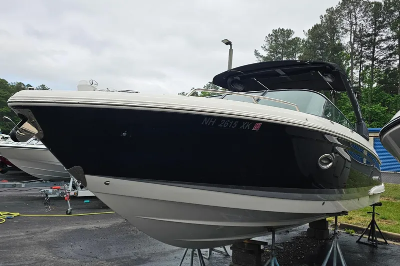 Slide: The Image of 2021 Chaparral 307 SSX boat on display, black and white exterior, parked outdoors. - 4