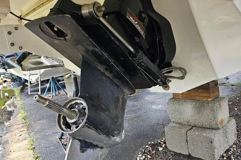 Slide: The Image of 2021 Chaparral 307 SSX boat outdrive on blocks, showing mechanical components. - 40