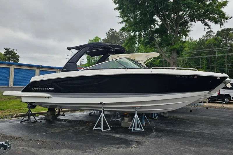Slide: The Image of 2021 Chaparral 307 SSX boat on stands, black and white exterior, outdoor setting. - 41
