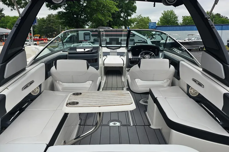 Slide: The Image of 2021 Chaparral 307 SSX boat interior with luxurious seating and modern dashboard. - 6
