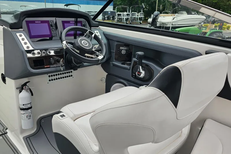 Slide: The Image of Cockpit of 2021 Chaparral 307 SSX boat with modern controls and steering wheel. - 7