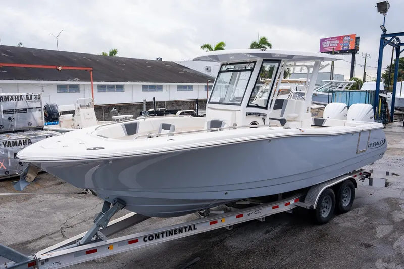 The Image of 2025 Robalo R270 Center Console boat on trailer, displayed outdoors. - 1
