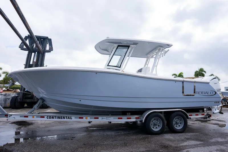 Slide: The Image of 2025 Robalo R270 Center Console boat on a trailer, ready for transport. - 2
